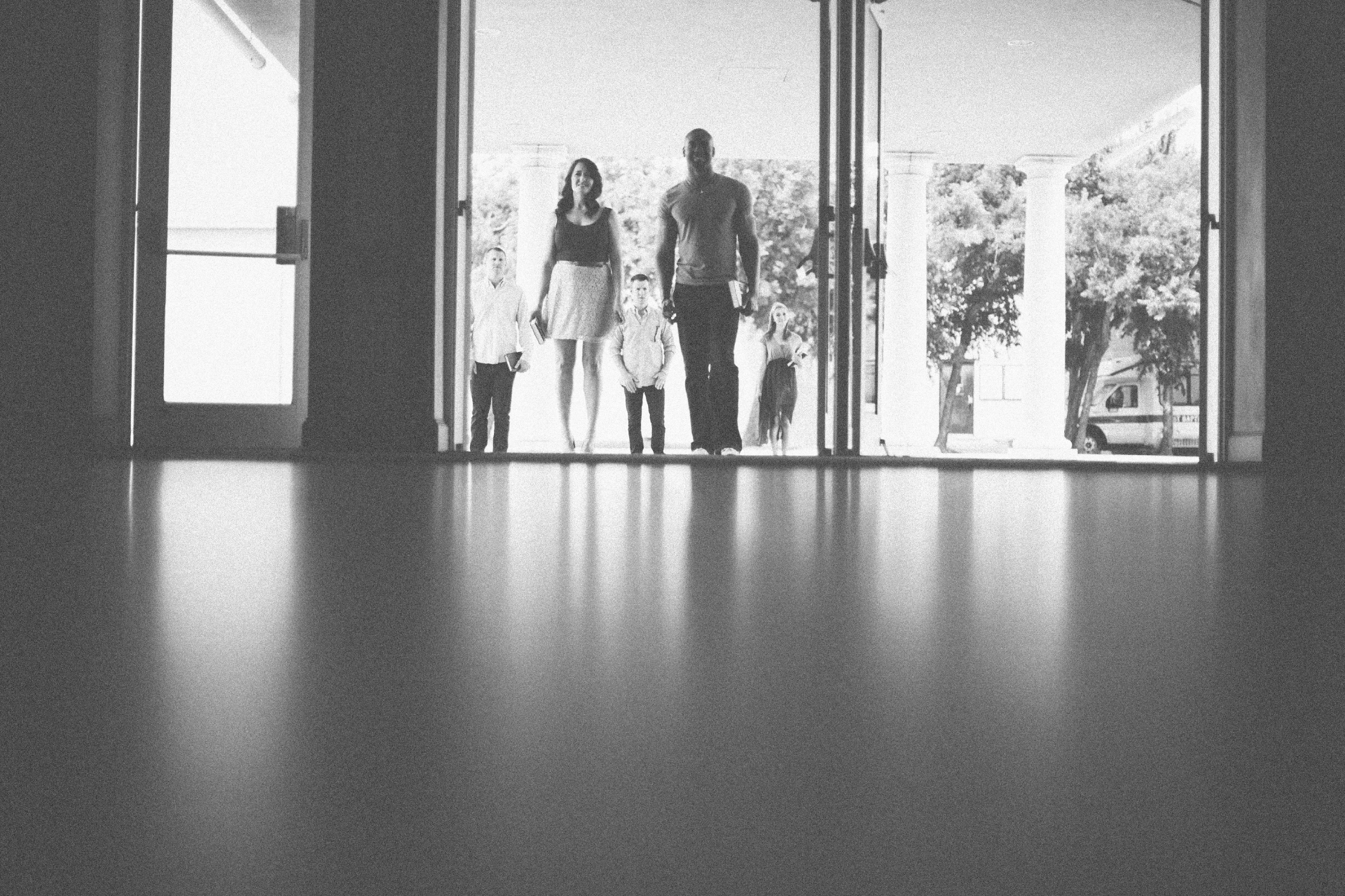 A family walks into church through open double doors